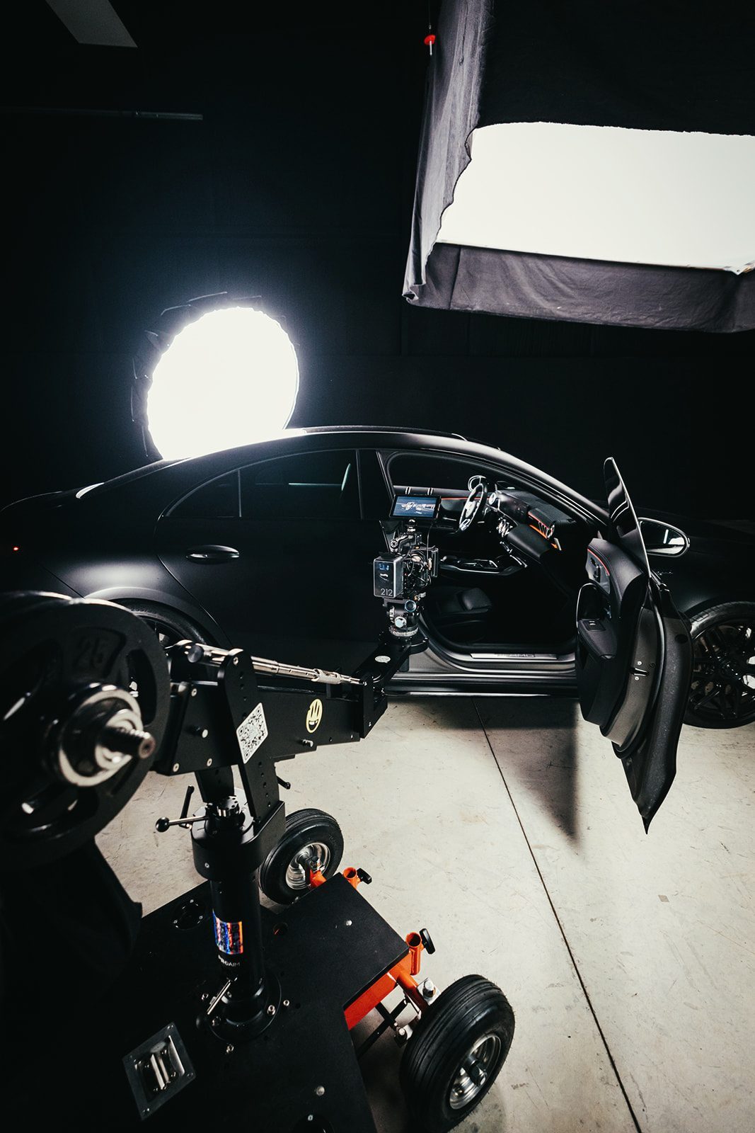 Filming the Mercedes AMG in the studio, camera rigged at the open driver's door